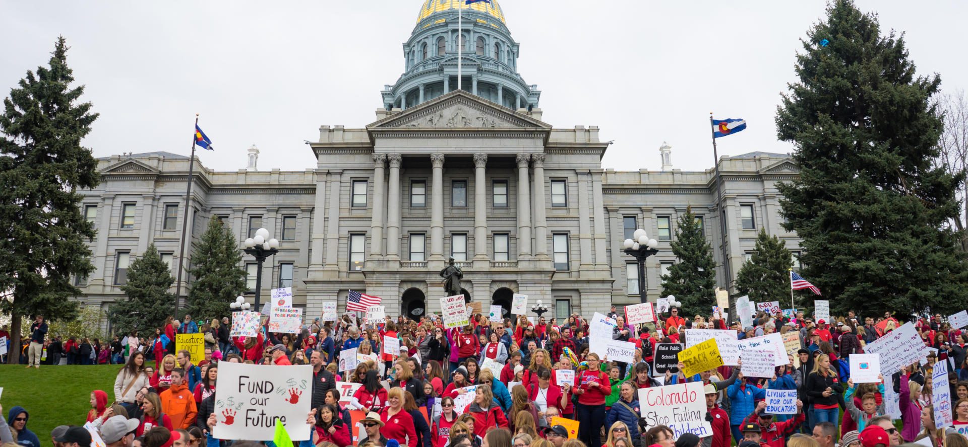 capitol pic Colorado Education Association members rally in front of the Colorado state capitol building wearing red and carrying signs and banners