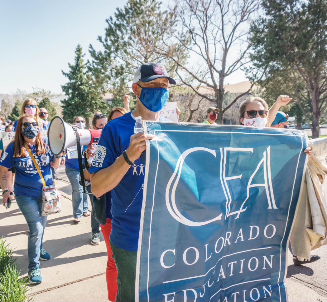 cea rally sign Photo of Colorado Education Association members carrying a CEA banner at a rally for fair pay and benefits