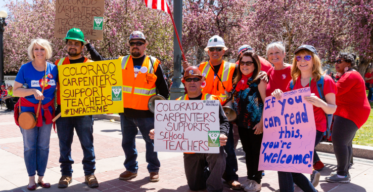 Construction workers show their support of educators at a Red for Ed Day of Action.